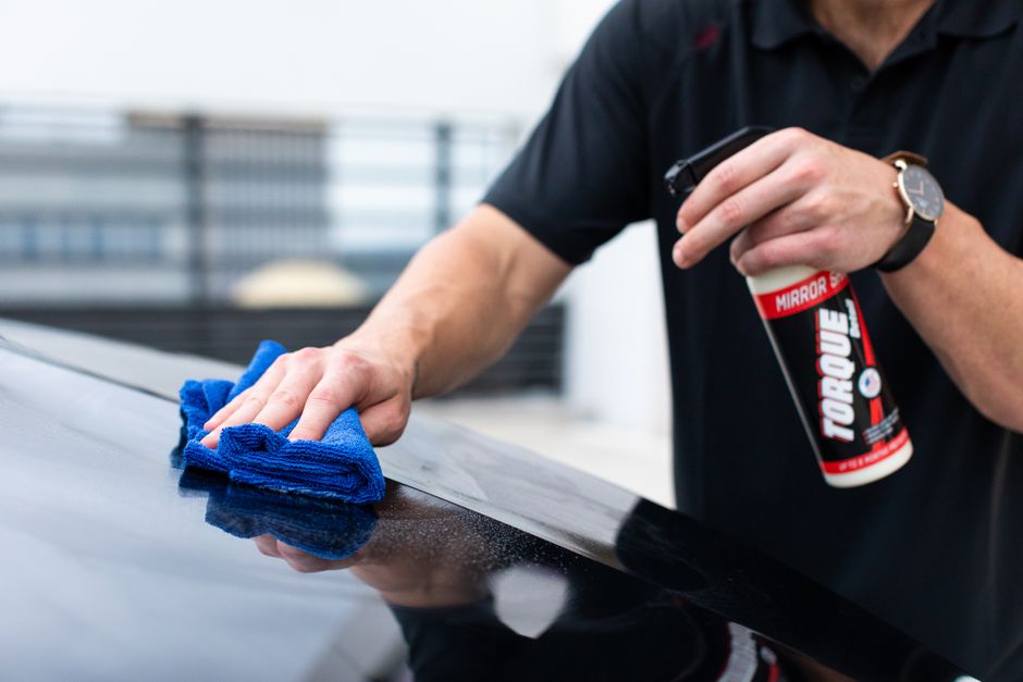 Polishing a car with a microfiber towel